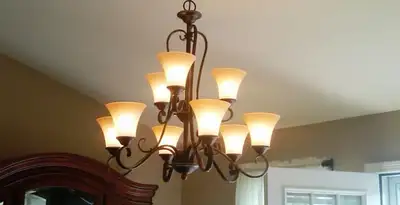 Classic ceiling chandelier installation with warm lighting in Chicago, IL