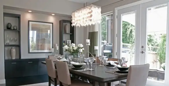 Elegant dining room chandelier installation above table in Chicago, IL