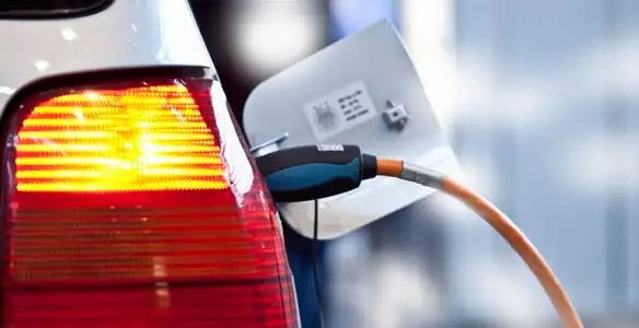 Electric car plugged into EV charger after professional installation in Chicago, IL