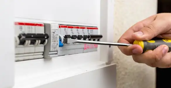 electrical panel upgrade service showing technician adjusting circuit breakers during system upgrade in Chicago, IL
