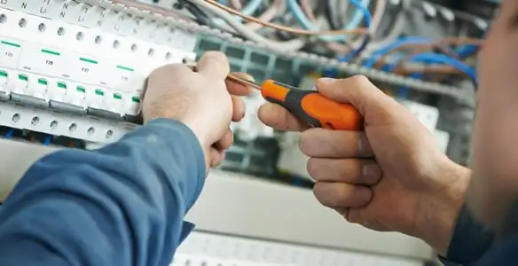 electrical service showing licensed electrician performing electrical panel maintenance and adjustments in Chicago, IL