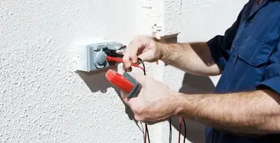 Electrician performing home electrical outlet and wiring inspection in Chicago, IL