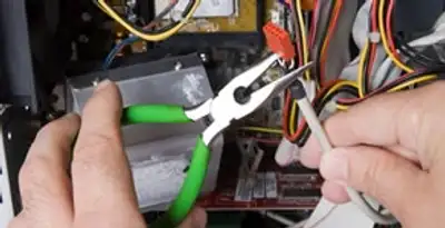 Licensed electrical contractor performing electrical repair with tools in Berwyn, IL
