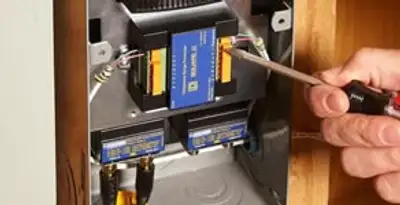 Whole home surge protection device being installed by a licensed electrician to protect electrical systems in Chicago, IL
